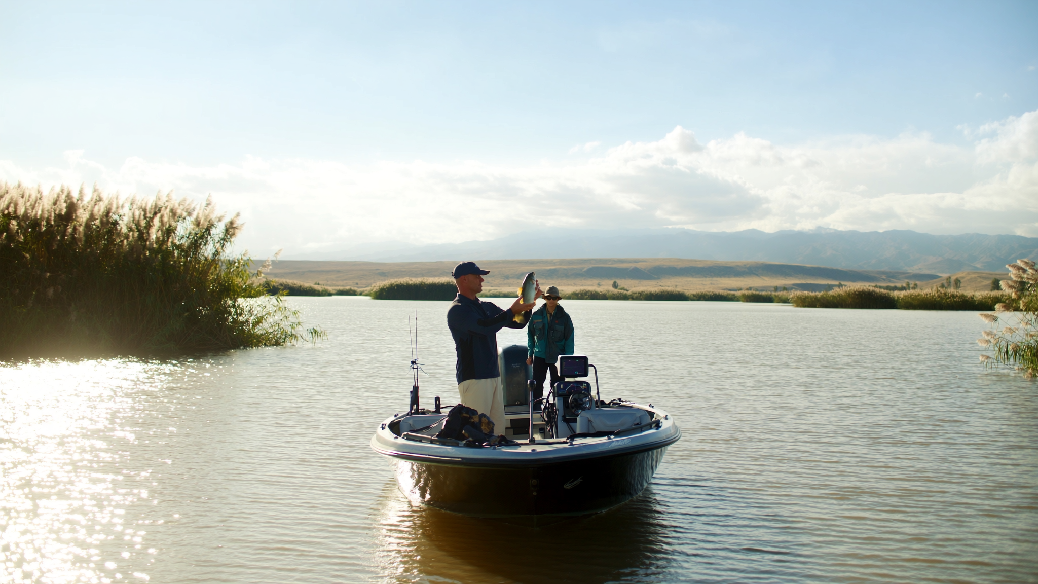Clear Lake bass anglers at golden hour with Mount Konocti in the background